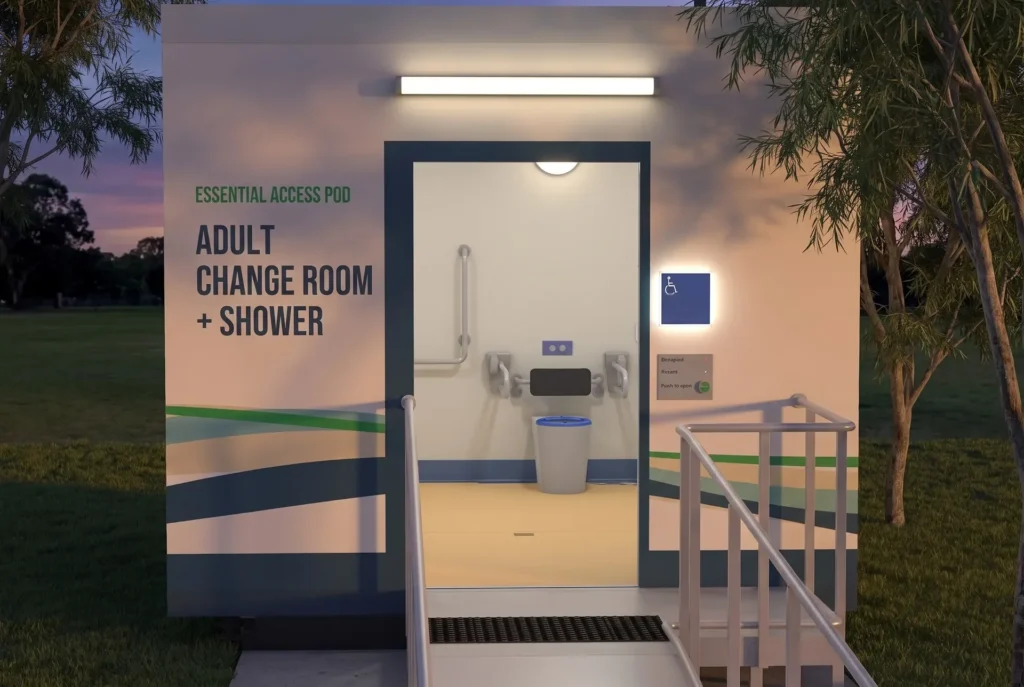 Concept render of the Fortitude Essentials Essential Access Pod, adult change room with shower, entrance ramp and landing in a suburban park at dusk.